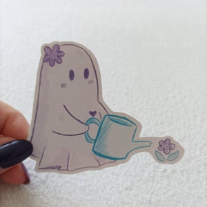 May include: A white ghost with a purple flower on its head is holding a blue watering can and watering a purple flower.