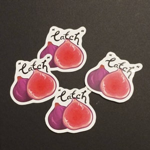May include: Four stickers with a purple fig and a red fig cut in half. Each sticker has the word "catch" written in cursive with quotation marks.