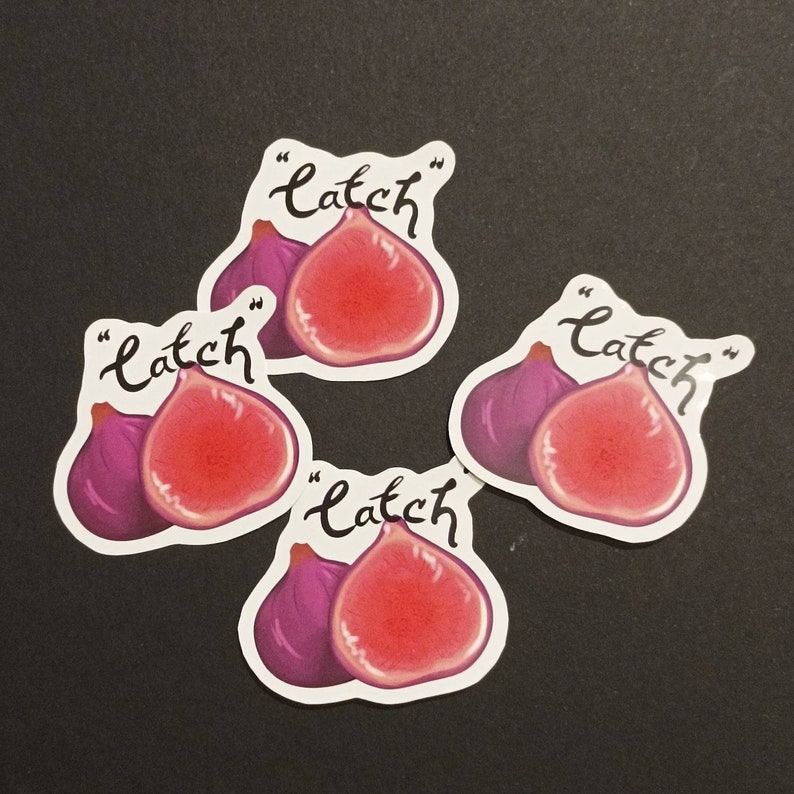 May include: Four stickers with a purple fig and a red fig cut in half. Each sticker has the word "catch" written in cursive with quotation marks.