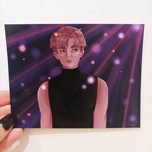 May include: A digital illustration of a person with pink hair wearing a black sleeveless turtleneck shirt. The background is a purple and pink gradient with white dots and light beams.