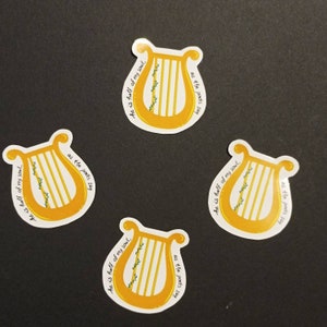 May include: Four yellow and white stickers with a lyre design and the text "He is half of my soul, as the poets say".