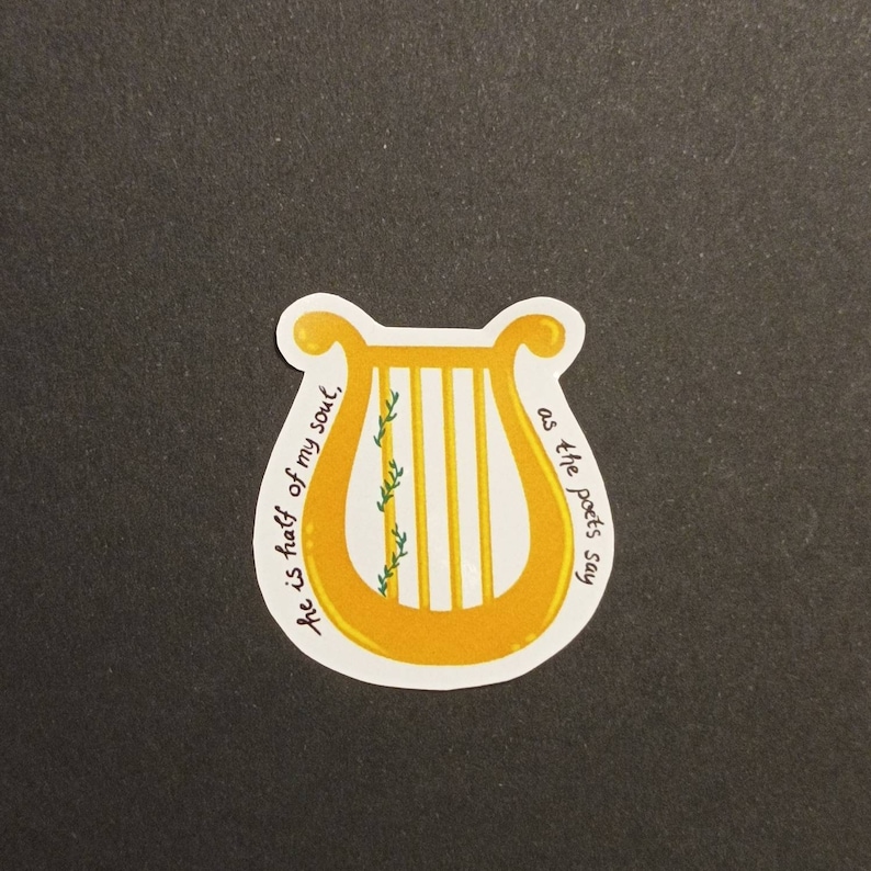 May include: A yellow lyre with a green vine growing up the side. The text "He is half of my soul, as the poets say" is written around the lyre.