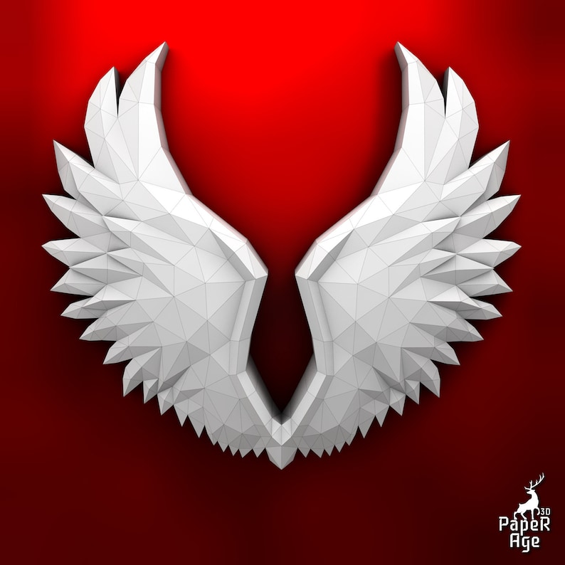 Puede incluir: Alas de &aacute;ngel de papel blanco con un dise&ntilde;o geom&eacute;trico, sobre un fondo rojo.