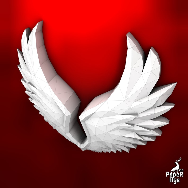 Puede incluir: Alas blancas de papel con un dise&ntilde;o geom&eacute;trico, dobladas en forma de coraz&oacute;n. Las alas est&aacute;n sobre un fondo rojo.
