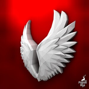 Puede incluir: Alas blancas de papel con un dise&ntilde;o geom&eacute;trico. Las alas est&aacute;n dobladas y tienen un efecto 3D. El fondo es rojo.