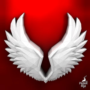 Puede incluir: Alas de papel origami blanco con un dise&ntilde;o geom&eacute;trico. Las alas est&aacute;n dobladas en forma 3D y se colocan sobre un fondo rojo.