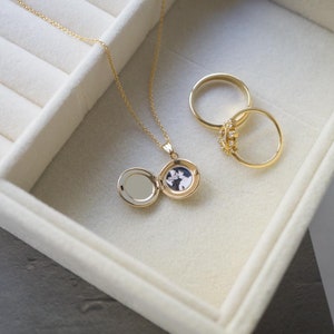 round gold locket with photo