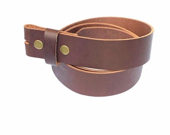 May include: A brown leather belt strap with two brass rivets. The strap is rolled up and ready to be cut to size.