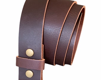 May include: A brown leather belt with a buckle and two brass rivets. The belt is rolled up and the buckle is visible.