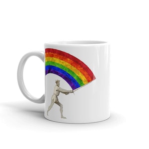 May include: White ceramic mug with a rainbow flag design. A figure with a crown is holding the flag with a sword.