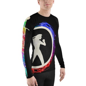 May include: Black long-sleeve shirt with a colorful abstract design featuring a silhouette of a person in a fighting pose. The design includes a circle with a rainbow-colored border.