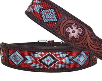 May include: A brown leather dog collar with a beaded design featuring red, white, and blue accents. The collar has a floral tooled design and a silver buckle.