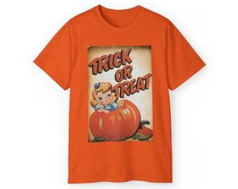 May include: Orange t-shirt with a vintage illustration of a girl in a blue dress sitting inside a pumpkin. The text "Trick or Treat" is printed in black letters on a tan background.