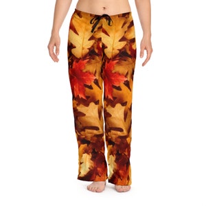 May include: A pair of brown and orange pajama pants with a fall leaf print. The leaves are in shades of red, orange, yellow, and brown.
