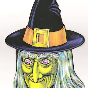 May include: A vintage Halloween decoration featuring a witch's face and hat. The witch has a green face, pink eyes, and long, white hair. The black hat has an orange band with a gold buckle. A classic Halloween decoration.