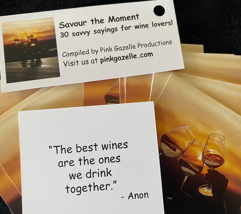 Op de afbeelding: Een set witte kaarten met de tekst Savour the Moment 30 savvy sayings for wine lovers, Compiled by Pink Gazelle Productions, Visit us at pinkgazelle.com, en een kaart met het citaat The best wines are the ones we drink together. - Anon.