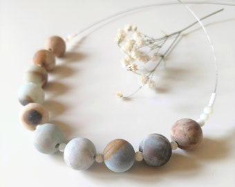 Aurora borealis iridescent light catching glass bead bone colored howlite spike dreamy modern bohochic earthy unique statement necklace