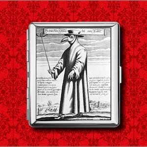 May include: A silver cigarette case featuring a black and white illustration of a plague doctor. The image includes text at the top and along the sides. The background is a red floral pattern.