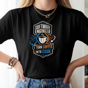 May include: A black t-shirt featuring a graphic design with the text "SOFTWARE ENGINEER" and "I TURN COFFEE INTO CODE". The design includes a white coffee cup with curly brackets, circuit board lines, and orange and blue accents.