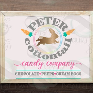 May include: A pink and gray sign with the text "Peter Cottontail Candy Company" and a cartoon bunny rabbit jumping over a rainbow. The sign also includes the text "Chocolate, Peeps, Cream Eggs".