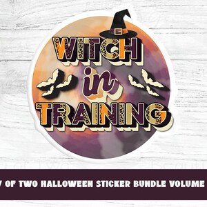 May include: A round sticker with a witch's hat, bats, and the text "WITCH in TRAINING" on a purple and orange background.