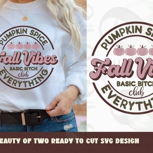 May include: A brown circle with the text "Pumpkin Spice Fall Vibes Basic Bitch Club Everything" in white and pink lettering. There are four pink pumpkins in the centre of the circle.