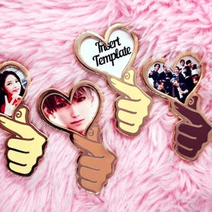 May include: Four gold heart-shaped pins with a hand gesture. Each pin has a different image inside the heart. One pin has the text "Insert Template".