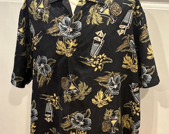 XXL Silk Tommy Bahama Hawaiian Aloha Shirt with a Black background and a Hawaiian drink motif in blues, greens, white, and yellow.