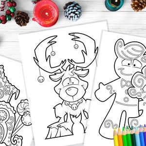 May include: Three Christmas-themed coloring pages featuring line art of a gingerbread house, a reindeer with bells, and gingerbread people. Colored pencils are visible at the bottom right, with holiday decorations in the background.