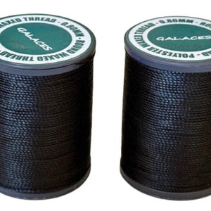 May include: Two spools of black waxed polyester thread. The spools have a dark gray base and a green and white label that reads "GALACES" and "Polyester Waxed Thread - 0.80mm". The thread is tightly wound.