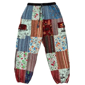 May include: Patchwork pants with a variety of patterns and colors. The pants feature a drawstring waist and multiple fabric squares with mushroom and floral designs. The color palette includes blue, red, brown, and green.