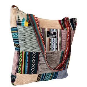 May include: A patchwork tote bag with a variety of colorful woven fabric panels. The bag features a long strap and a small pocket. The label reads "Zillion Craft Chicago, 2018".
