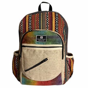 May include: A backpack featuring a multi-colored striped pattern with geometric accents, a beige front pocket with a diagonal zipper, and a black label reading ZILLION CRAFT CHICAGO, USA. The bag includes side pockets and a top handle.