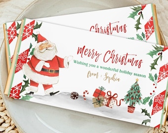 May include: Two Christmas-themed chocolate bars with festive designs. Each bar features a watercolor illustration of Santa Claus, holiday gifts, and a Christmas tree. The bars are decorated with the words "Merry Christmas" and "Wishing you a wonderful holiday season."