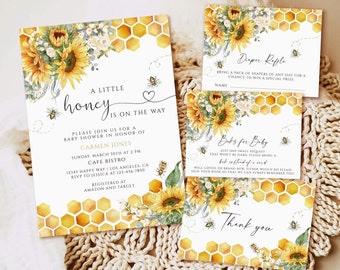 May include: A baby shower invitation with a sunflower and honeycomb design. The invitation reads "A Little Honey is on the Way" and includes details for the event, including the date, time, location, and RSVP information. The invitation also includes a diaper raffle and a request for gifts for the baby.