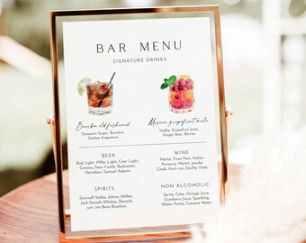 May include: A bar menu with a list of signature drinks, beer, wine, spirits, and non-alcoholic beverages. The menu is framed in a gold frame and is sitting on a wooden table. The signature drinks include a bourbon old fashioned and a Moscow grapefruit mule.