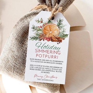 May include: A burlap bag with a tag that reads "Holiday Simmering Potpourri." The tag features a watercolor illustration of an orange slice, cinnamon sticks, and greenery. The bag is tied with twine and sits on a neutral-toned surface.