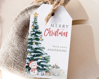 May include: A burlap gift bag with a white tag that reads "MERRY Christmas" in red script. The tag features a watercolor Christmas tree, snowman, and gifts. The tag is tied to the bag with twine.