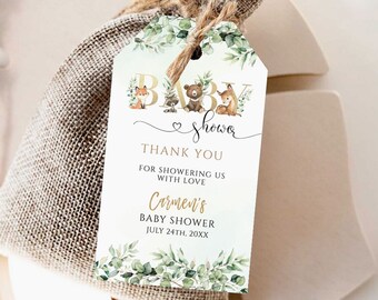 Op de afbeelding: Een wit bedankkaartje met gouden letters en een bosdierenthema. Het kaartje zegt "Baby Shower" met een hartje en de tekst "Bedankt voor het vieren met ons Carmen's Baby Shower 24 juli 20XX".
