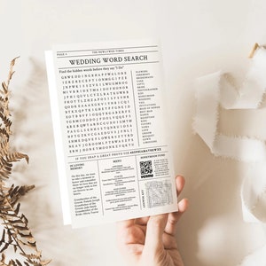 May include: A black and white wedding word search puzzle with a QR code for a honeymoon fund. The puzzle includes words like "wedding", "ceremony", "reception", "bride", "groom", and "honeymoon".