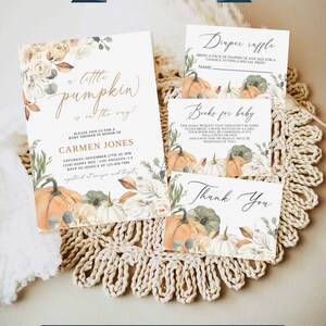 May include: Baby shower stationery set featuring pumpkin illustrations and floral accents. The invitation reads "a little pumpkin is on the way!". Includes a diaper raffle card, a book request card, and a thank you card, all with matching designs.