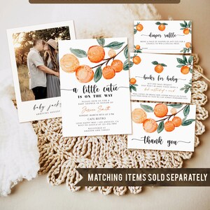 May include: A collection of baby shower stationery featuring watercolor orange branch designs. Includes an invitation, a photo card, a diaper raffle card, a book request card, and a thank you card. The invitation reads "A little cutie is on the way."