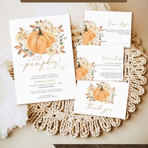 May include: A set of baby shower stationery featuring watercolor pumpkin and floral illustrations. The cards include an invitation with the text a little pumpkin is on its way, a diaper raffle card, a books for baby card, and a thank you card.