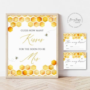 May include: A framed sign and two smaller cards with a bee-themed design. The sign reads "Guess How Many Kisses For The Soon-To-Be Mrs." in gold script. The background features a honeycomb pattern.