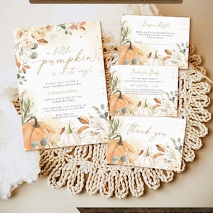 May include: Baby shower stationery set with a pumpkin theme. The invitation says "a little pumpkin is on its way!" with pumpkin and floral illustrations. Includes a diaper raffle card, a book request card, and a thank you card.