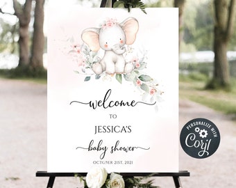 May include: A white sign on a black easel with a watercolor illustration of a baby elephant wearing a floral crown. The sign reads "welcome to Jessica's baby shower" and "October 21st, 2021".