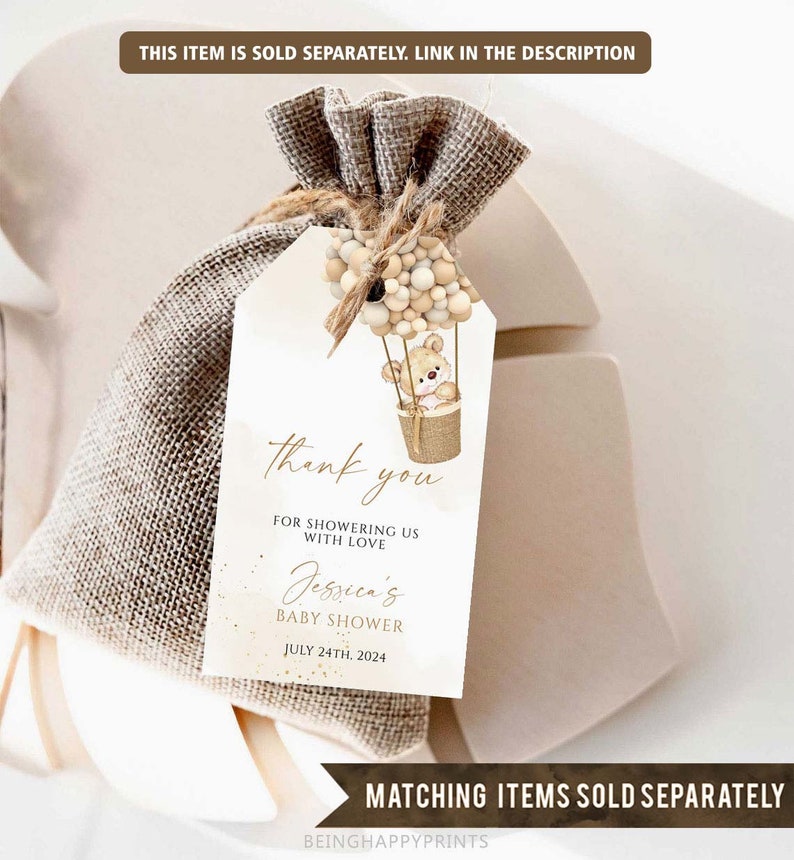 May include: A white thank you tag with a brown teddy bear in a hot air balloon with beige and brown balloons. The tag says "Thank you for showering us with love Jessica's Baby Shower July 24th, 2024".