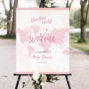 Cartel de bienvenida para baby shower con el lema "Aventuras en el mundo" y el lema "Aventuras en el mundo" Cartel de bienvenida para bebé con tema de viajes y maleta rosa para niña