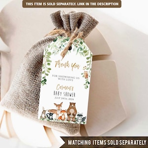 May include: A white thank you tag with green foliage and woodland animals. The text reads "Thank You for showering us with love Carmen's Baby Shower July 24th, 2024".