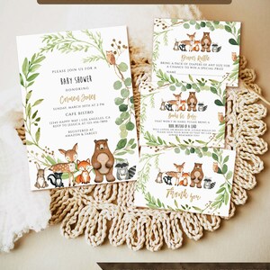 May include: A woodland-themed baby shower invitation with a green and brown color scheme. The invitation features a watercolor illustration of woodland animals, including a deer, fox, bear, raccoon, and rabbit. The text on the invitation reads "Please join us for a baby shower honoring Carmen Jones".
